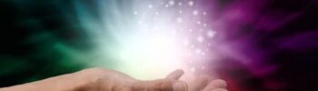Bright mystical light emanating from an open hand with colourful cosmic effects, highlighting innovative lighting solutions.