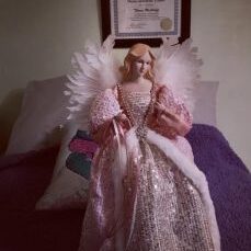 Elegant angel figurine with fairy wings and a sparkly gown representing healing and positivity.