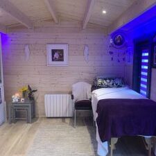 Soft ambient LED lighting in cosy bedroom with wooden interior and decorative accents.